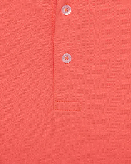 Close-up of orange golf polo fabric with button placket detail