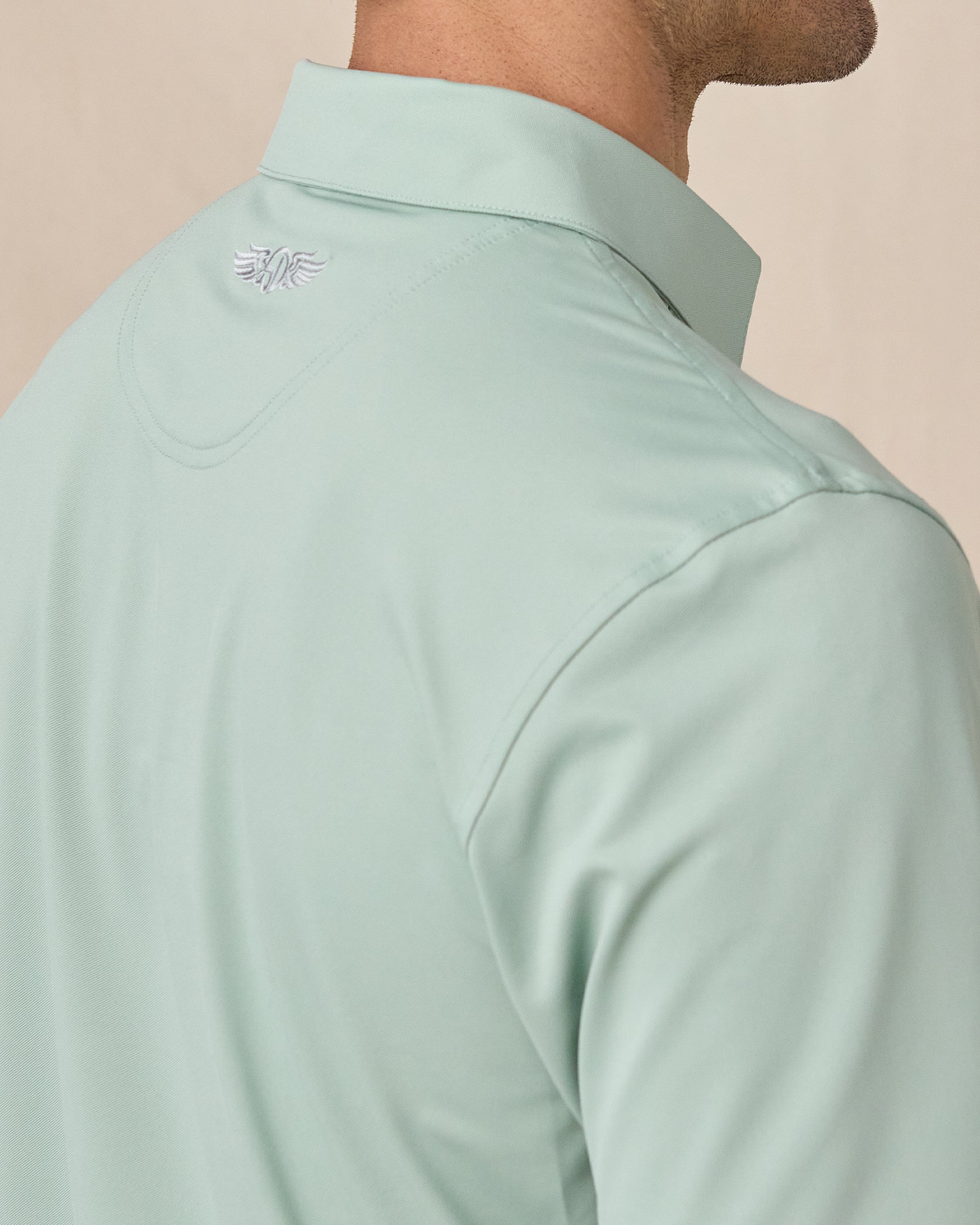 Sullivan Polo in Herb Green with embroidered back neck logo detail close-up