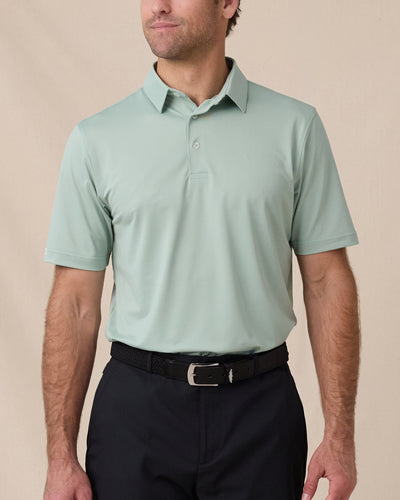 Sullivan Polo in Herb Green worn with black golf shorts, front model view