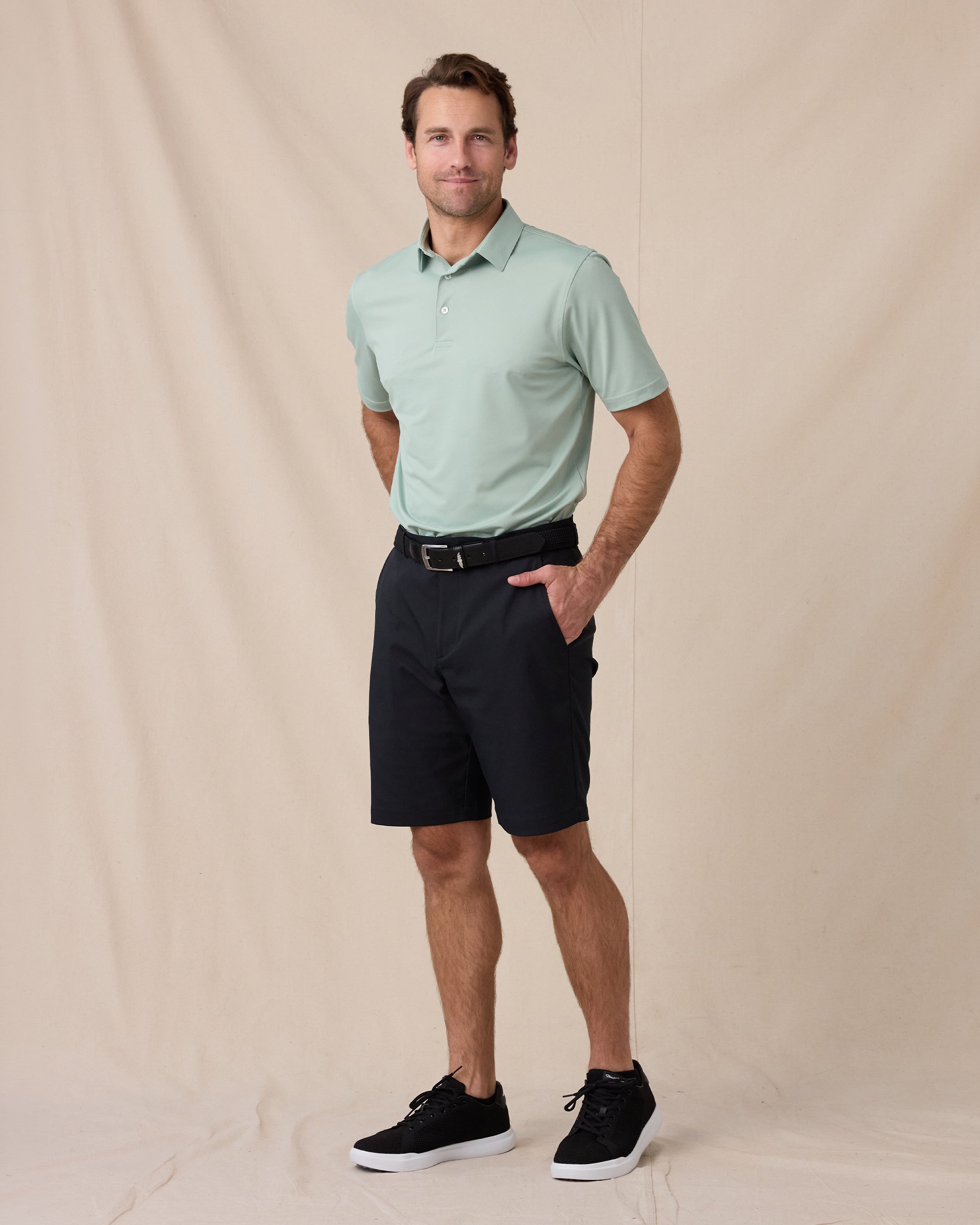 Sullivan Polo in Herb Green with black golf pants, full outfit model view