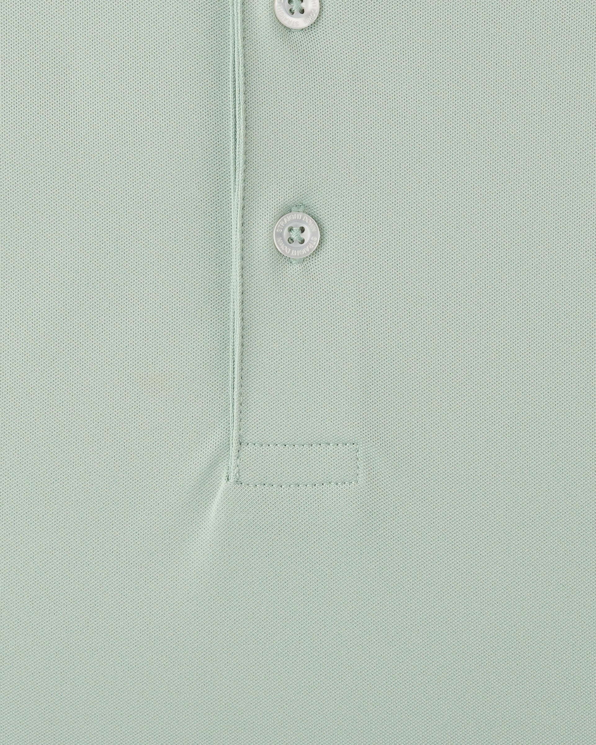 Close-up of light green golf polo fabric with button placket detail