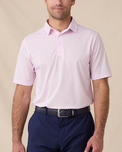 Model wearing the Sullivan Polo in Lilac, a solid-color performance golf polo