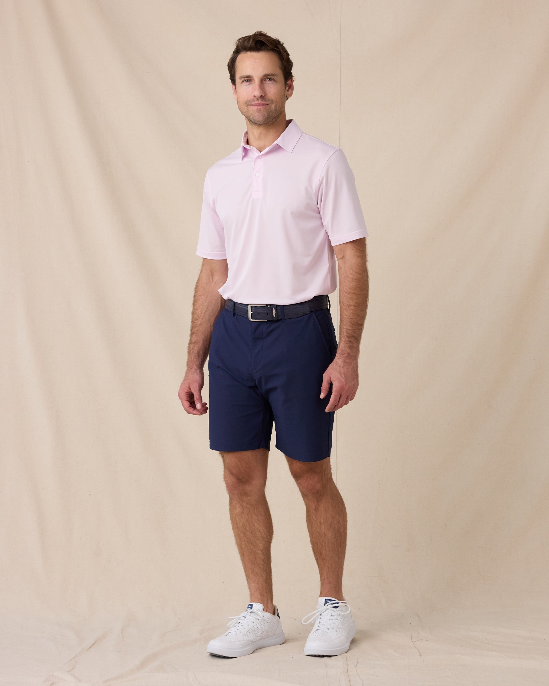Model wearing the Sullivan Polo in Lilac paired with navy golf shorts