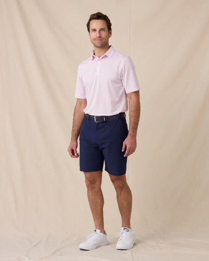 Model wearing the Sullivan Polo in Lilac paired with navy golf shorts