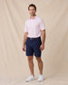 Model wearing the Sullivan Polo in Lilac paired with navy golf shorts