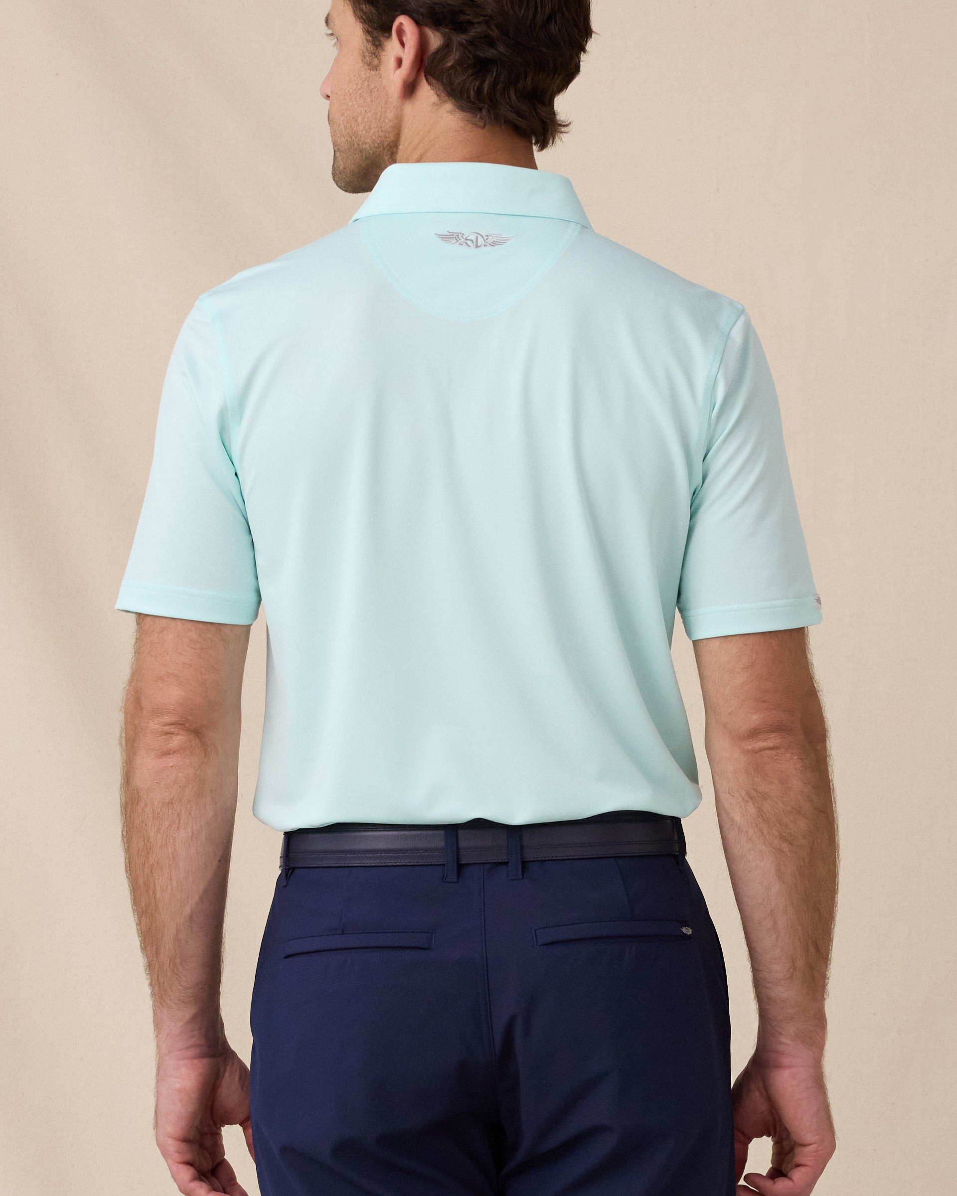 Sullivan Polo in Mint Tea, back view with embroidered logo detail