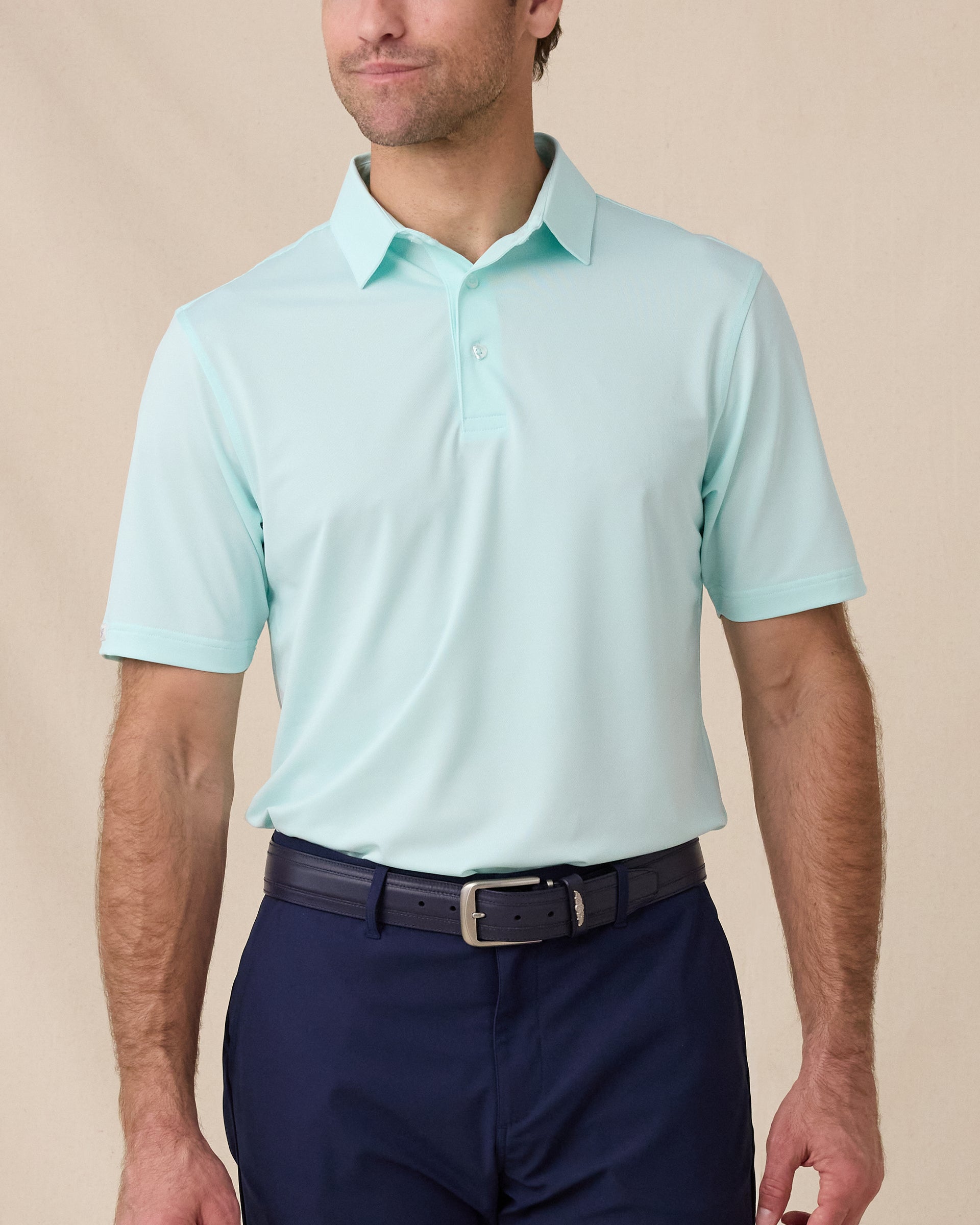 Sullivan Polo in Mint Tea worn with navy golf shorts, front model view