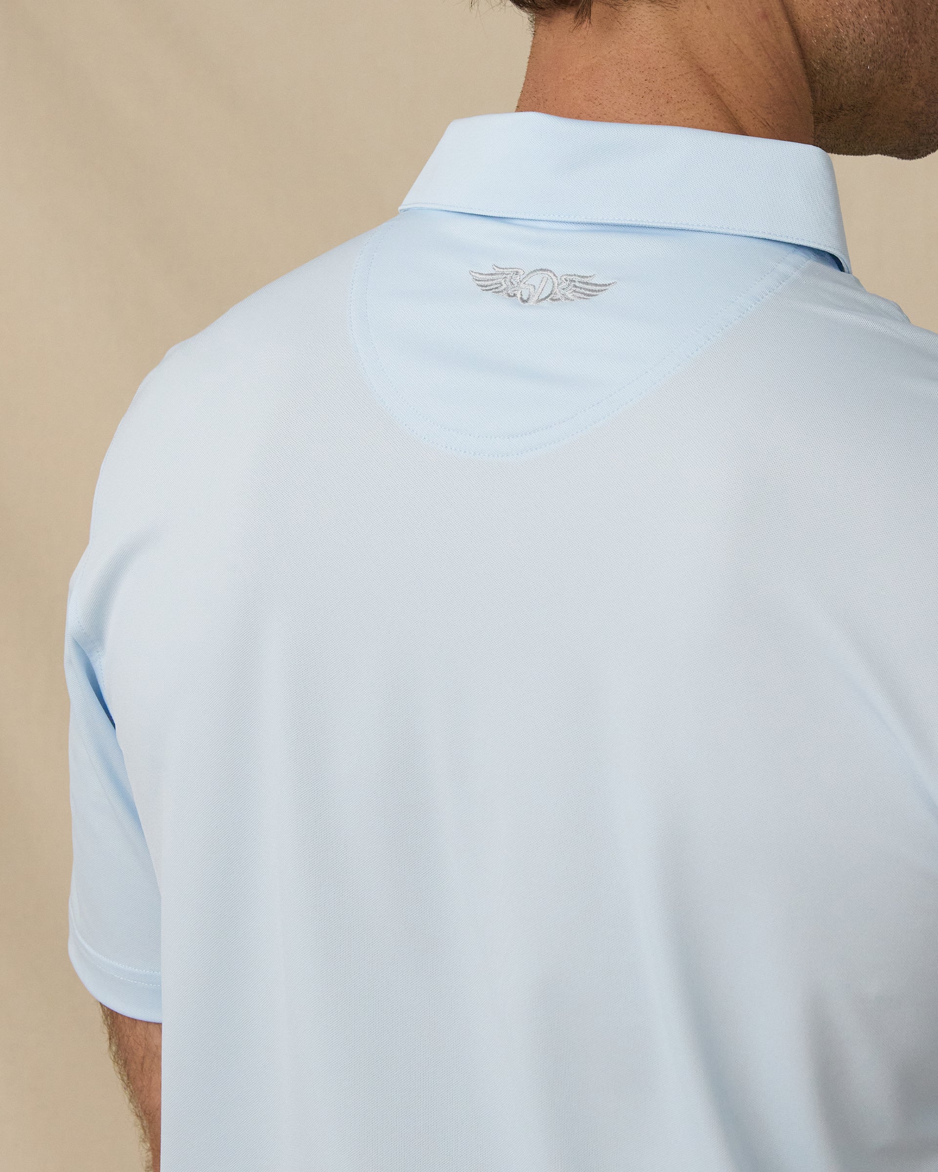 Sullivan Polo in Nantucket blue with embroidered back neck logo detail close-up