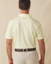 Men’s Sullivan Polo in pale yellow worn with khaki shorts, back view