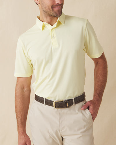 Men’s Sullivan Polo in pale yellow worn with khaki shorts, front view