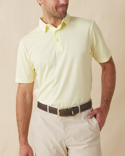 Men’s Sullivan Polo in pale yellow worn with khaki shorts, front view