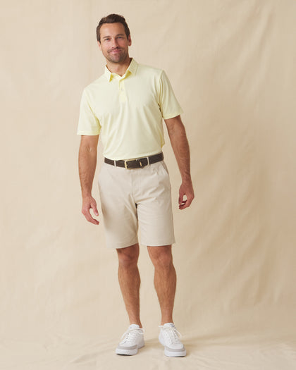 Men’s Sullivan Polo in pale yellow worn with khaki shorts, full-body view