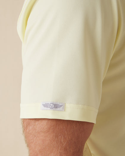 Close-up of the Sullivan Polo sleeve logo tab in pale yellow