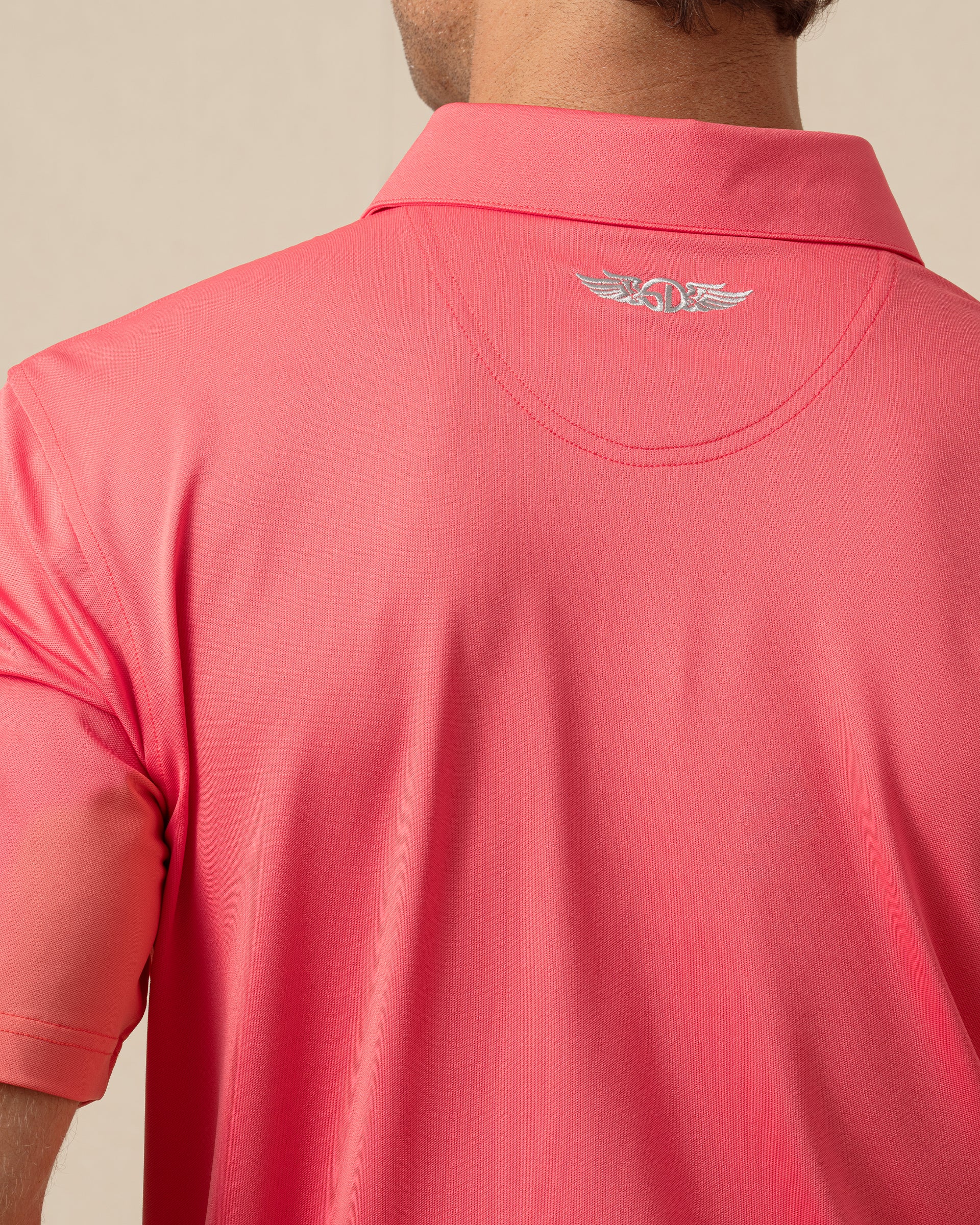 Sullivan Polo in Shine with embroidered back neck logo, close-up view