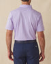 Men’s Sullivan Polo in violet worn with navy shorts, back view