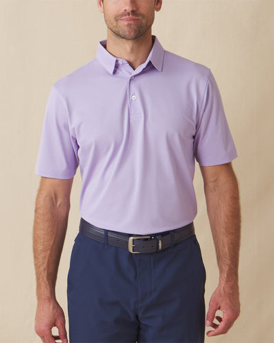 Men’s Sullivan Polo in violet worn with navy shorts, front view