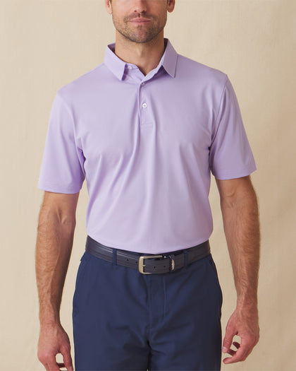 Men’s Sullivan Polo in violet worn with navy shorts, front view