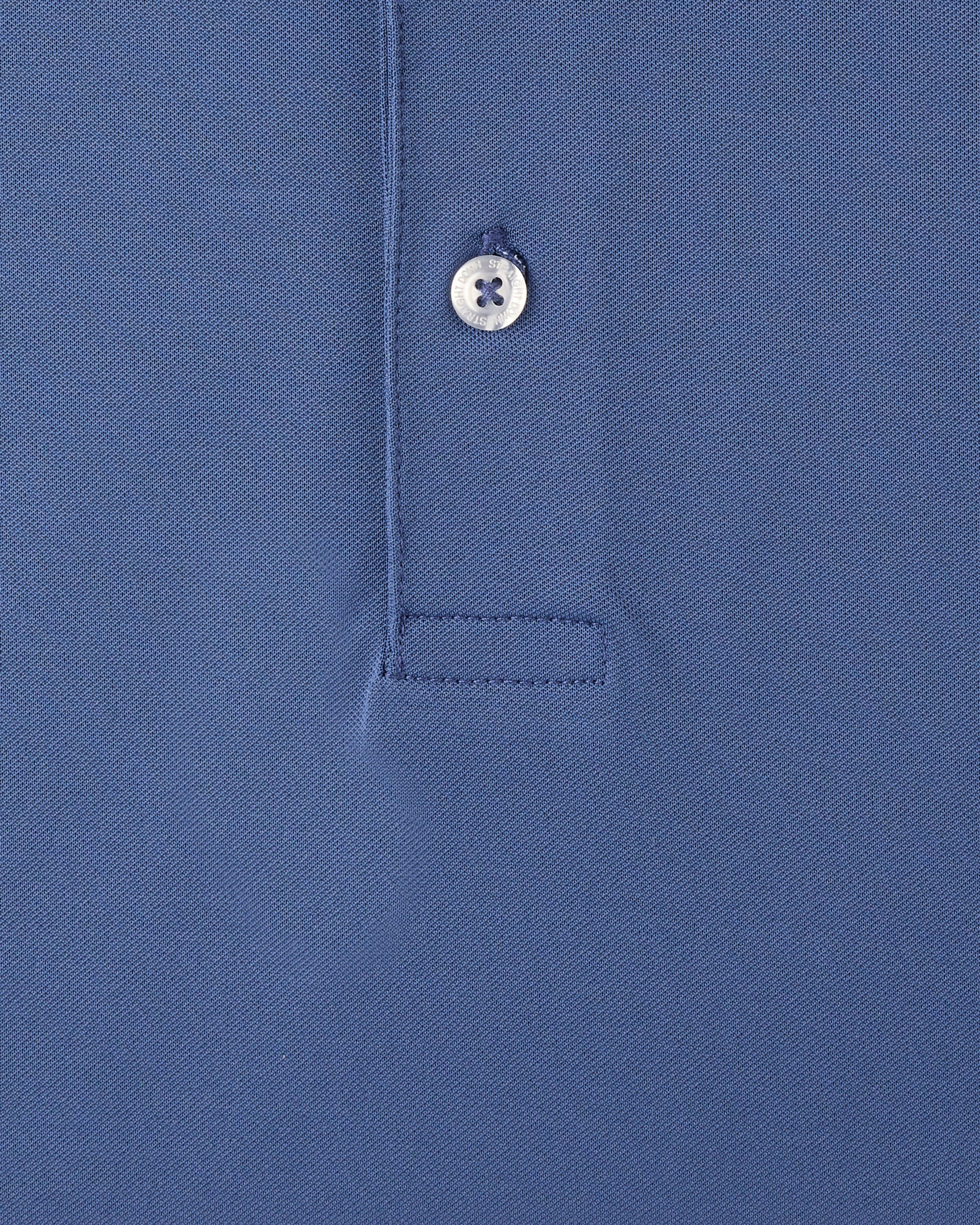 Close-up of a blue polo shirt showing the collar area with a single white button and a stitched pocket detail.