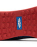 Men's Field V2 Shoe in Camo Indigo, close-up outsole view featuring a red rubber outsole with multi-directional traction lugs and a blue branded logo badge