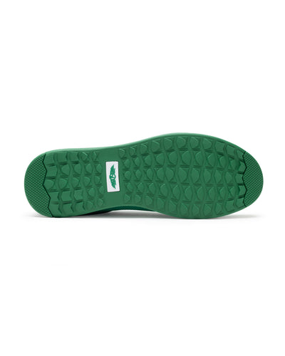Men's Field V2 Shoe in Green, bottom sole view featuring a green rubber outsole with multi-directional traction lugs and a white branded logo badge