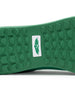 Men's Field V2 Shoe in Green, close-up outsole view featuring a green rubber outsole with multi-directional traction lugs and a white branded logo badge