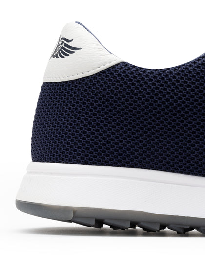 Men's Field V2 Shoe in Indigo, close-up heel detail view featuring the navy mesh knit upper, white heel tab with SD wing logo, and white midsole