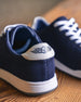 Men's Field V2 Shoe in Indigo, close-up back detail view of both shoes featuring the navy mesh knit upper and white leather heel tab with SD wing logo