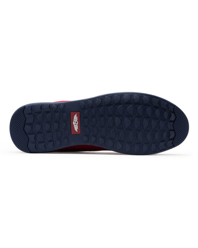 Men's Field V2 Shoe in Red, bottom sole view featuring a navy rubber outsole with multi-directional traction lugs and a branded logo badge
