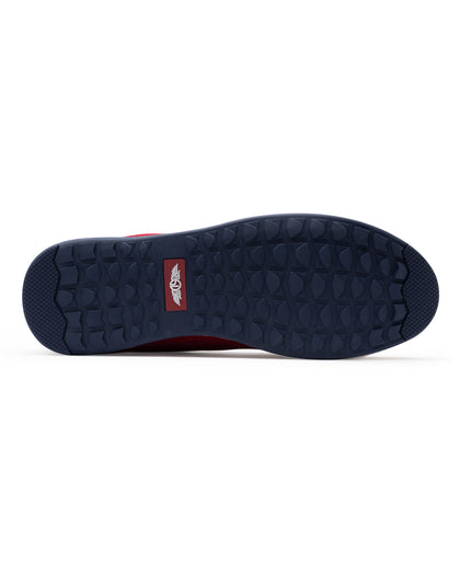 Men's Field V2 Shoe in Red, bottom sole view featuring a navy rubber outsole with multi-directional traction lugs and a branded logo badge