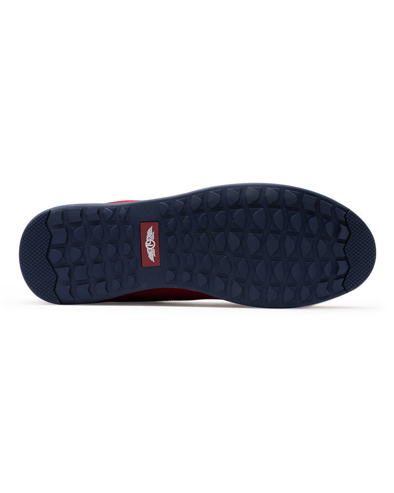 Men's Field V2 Shoe in Red, bottom sole view featuring a navy rubber outsole with multi-directional traction lugs and a branded logo badge