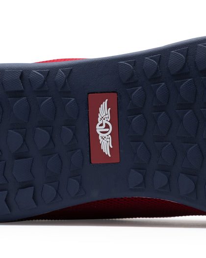 Men's Field V2 Shoe in Red, close-up outsole view featuring a navy rubber outsole with multi-directional traction outsole and a red branded logo badge
