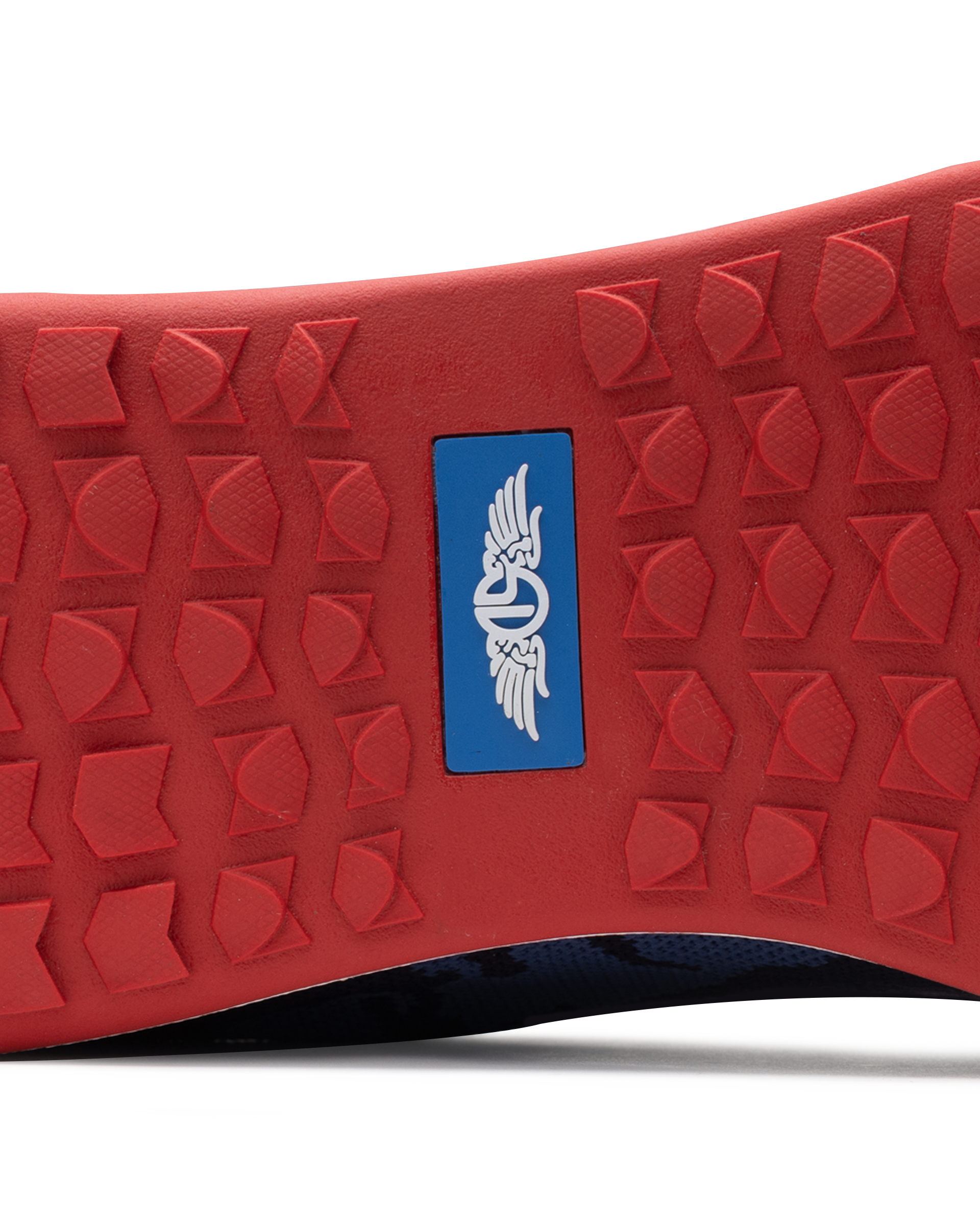 Men's Field V2 Shoe in Camo Indigo, close-up outsole view featuring a red rubber outsole with multi-directional traction lugs and a blue branded logo badge