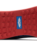 Men's Field V2 Shoe in Camo Indigo, close-up outsole view featuring a red rubber outsole with multi-directional traction lugs and a blue branded logo badge