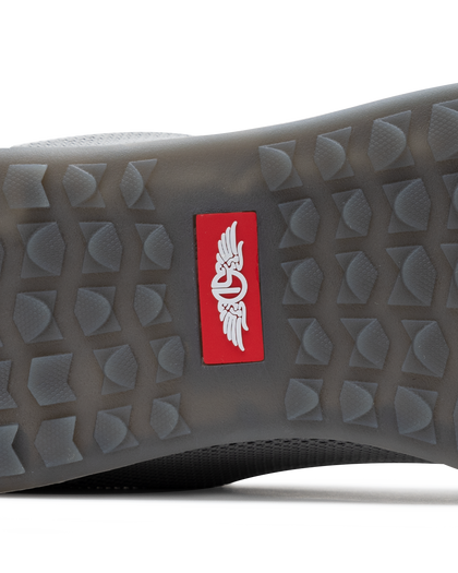 Men's Field V2 Shoe in Carbon, close-up outsole detail view featuring the gray traction outsole and red SD logo label