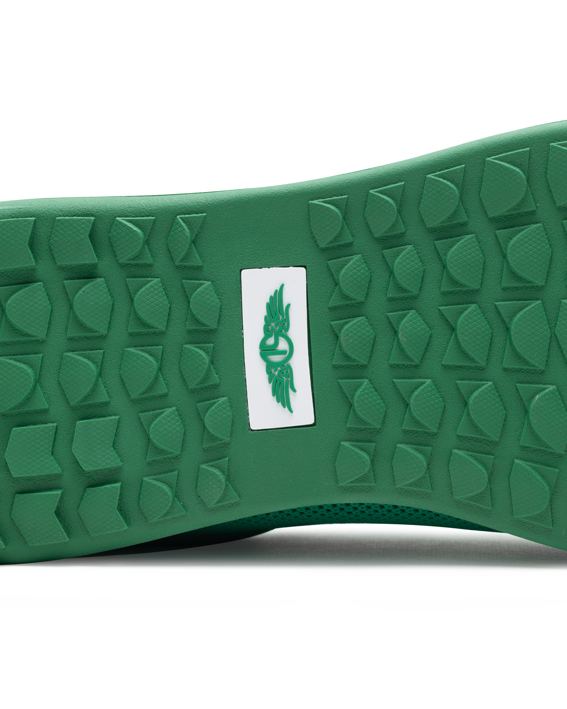 Men's Field V2 Shoe in Green, close-up outsole view featuring a green rubber outsole with multi-directional traction lugs and a white branded logo badge