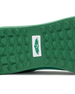 Men's Field V2 Shoe in Green, close-up outsole view featuring a green rubber outsole with multi-directional traction lugs and a white branded logo badge