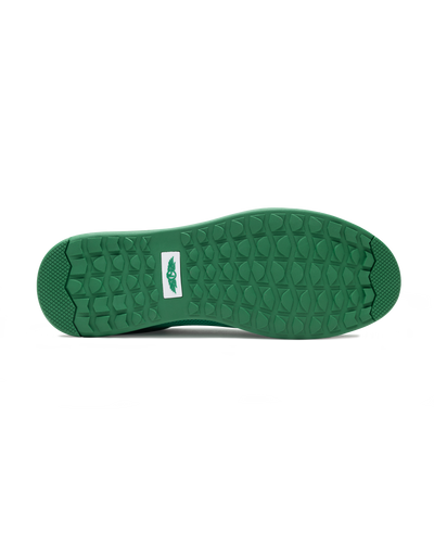 Men's Field V2 Shoe in Green, bottom sole view featuring a green rubber outsole with multi-directional traction lugs and a white branded logo badge