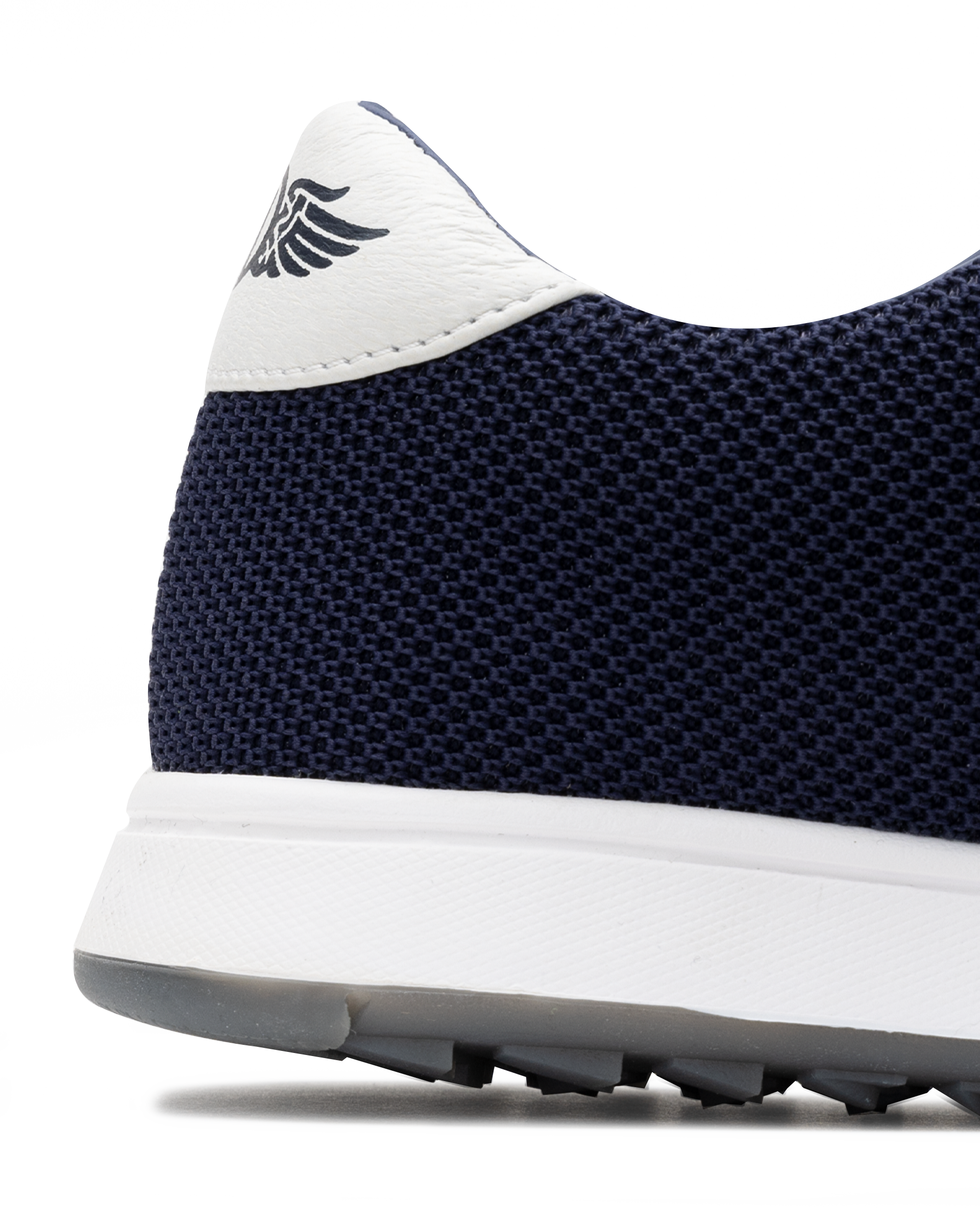 Men's Field V2 Shoe in Indigo, close-up heel detail view featuring the navy mesh knit upper, white heel tab with SD wing logo, and white midsole