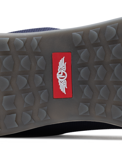 Men's Field V2 Shoe in Indigo, close-up outsole detail view featuring the gray traction outsole and red SD logo label