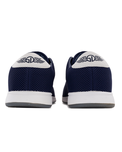 Men's Field V2 Shoe in Indigo, heel view featuring the navy mesh knit upper, white heel tab with SD wing logo, and white midsole