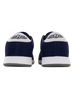 Men's Field V2 Shoe in Indigo, heel view featuring the navy mesh knit upper, white heel tab with SD wing logo, and white midsole