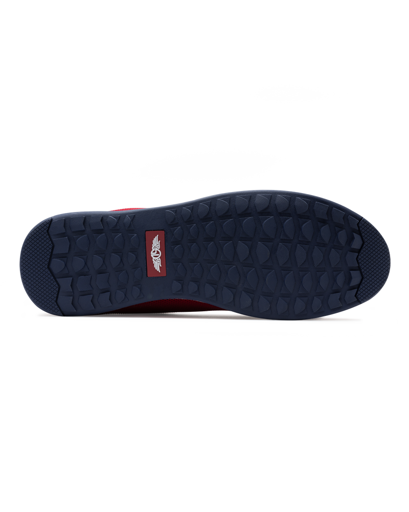 Men's Field V2 Shoe in Red, bottom sole view featuring a navy rubber outsole with multi-directional traction lugs and a branded logo badge