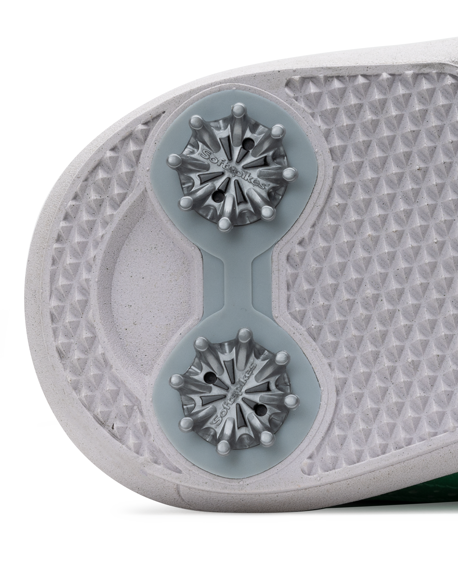 Close-up of the sole of a golf shoe, showing dual metallic cleats on a textured white and light gray outsole.