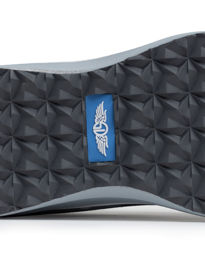Straight Down Mojave Shoe in Camo Carbon, close-up bottom view of the dark grey geometric textured outsole with Straight Down logo tab in blue