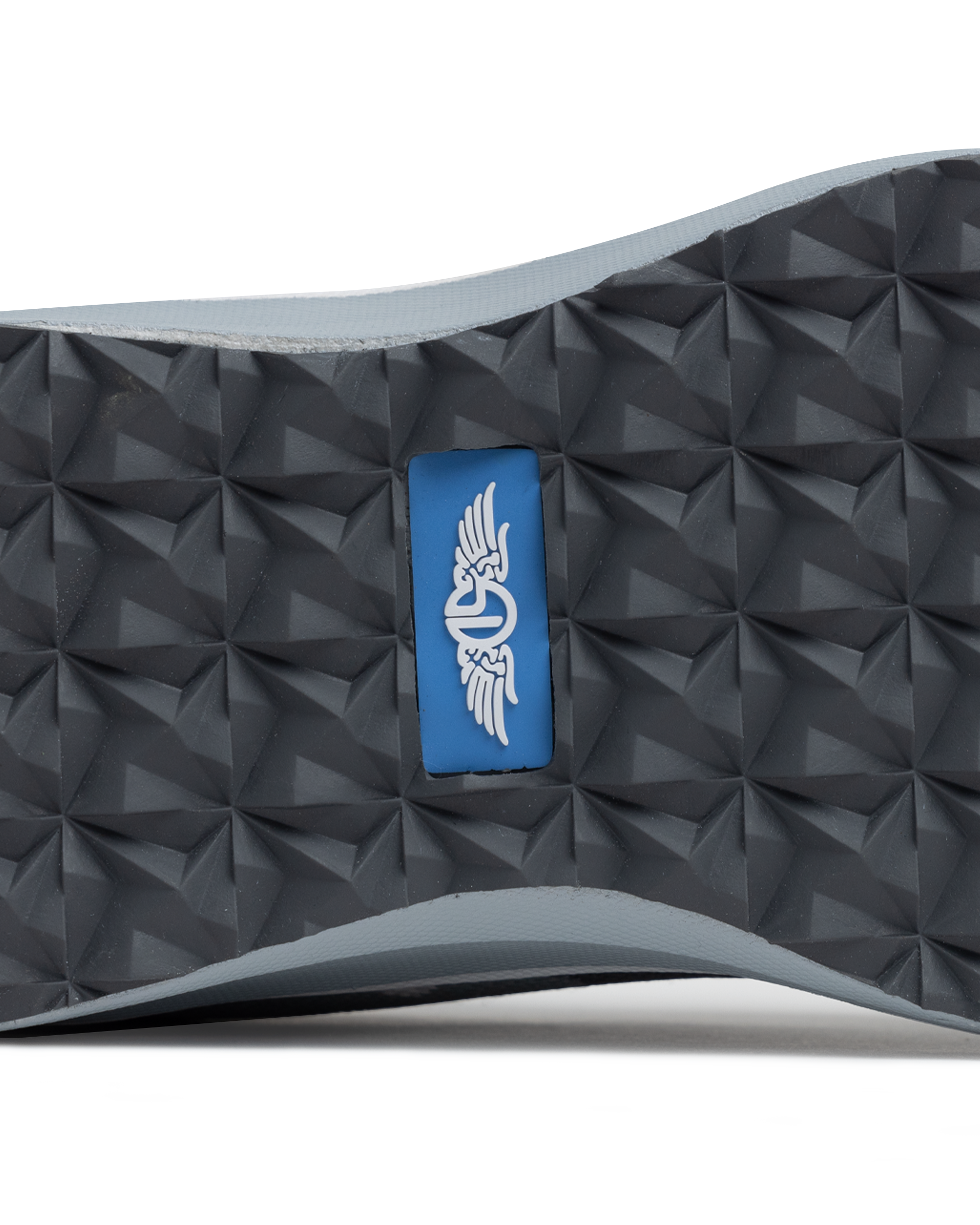 Straight Down Mojave Shoe in Camo Carbon, close-up bottom view of the dark grey geometric textured outsole with Straight Down logo tab in blue