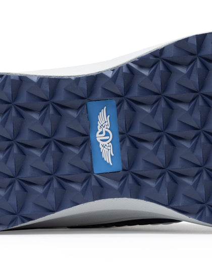 Men's Moonlight Shoe in Scuba, close up bottom view featuring a light blue knit upper with navy overlays, navy ribbed midfoot support cage with SD logo, white laces, and a white midsole
