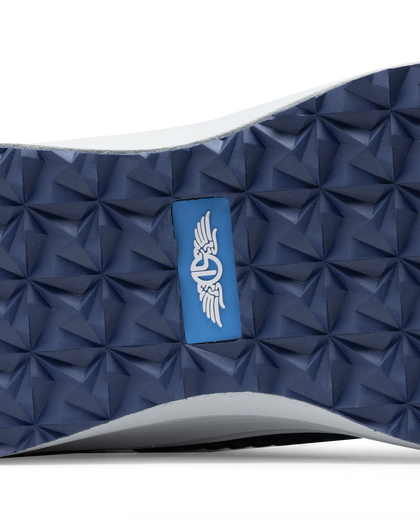 Straight Down Women's Moonlight Shoe in Scuba, close-up bottom view featuring navy traction outsole with geometric grip pattern and blue Straight Down logo badge