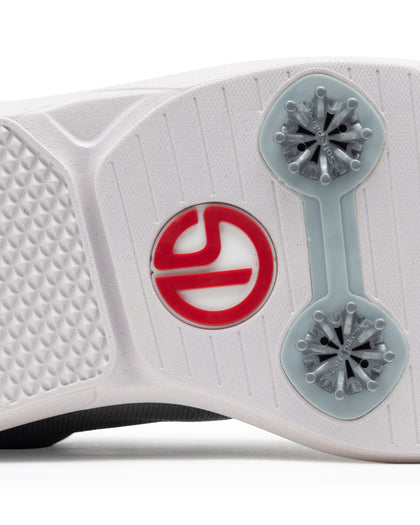 Straight Down Club Golf Shoe in Carbon, close-up bottom view showing white outsole with grey traction cleats and Straight Down logo in red