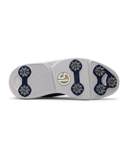 Men's Challenger Shoe in Indigo, bottom sole view featuring a white rubber outsole with navy spike cleats, textured traction zones, and a gold and white branded logo badge