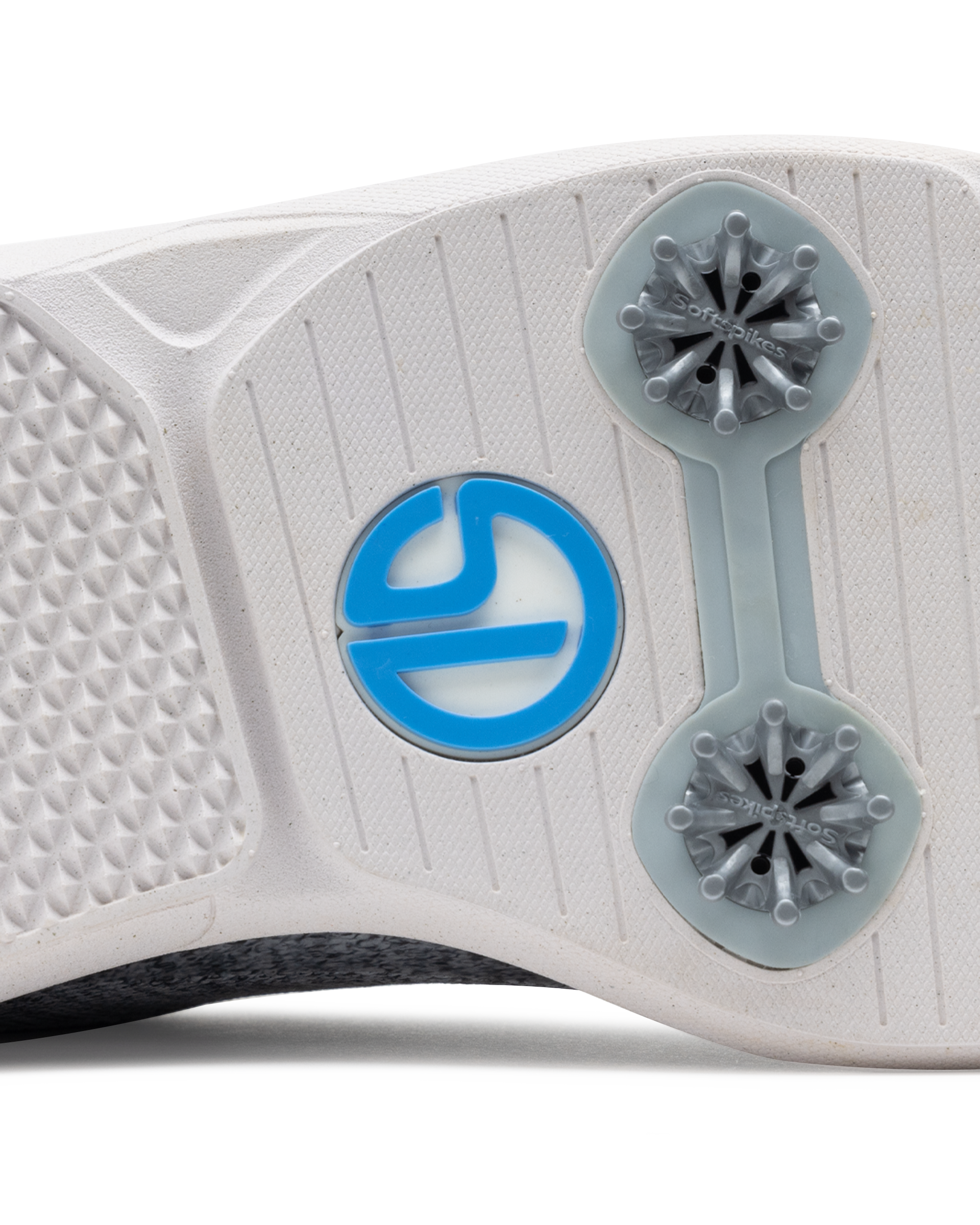 Men's Challenger Shoe in Carbon, close-up outsole view featuring a white rubber outsole with gray spike cleats and a blue branded logo badge detail